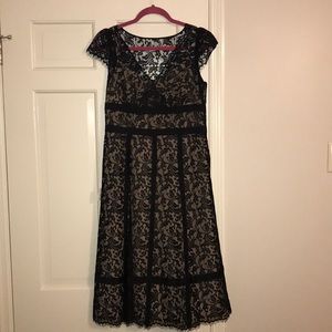 Black cap sleeved lace dress with tan slip